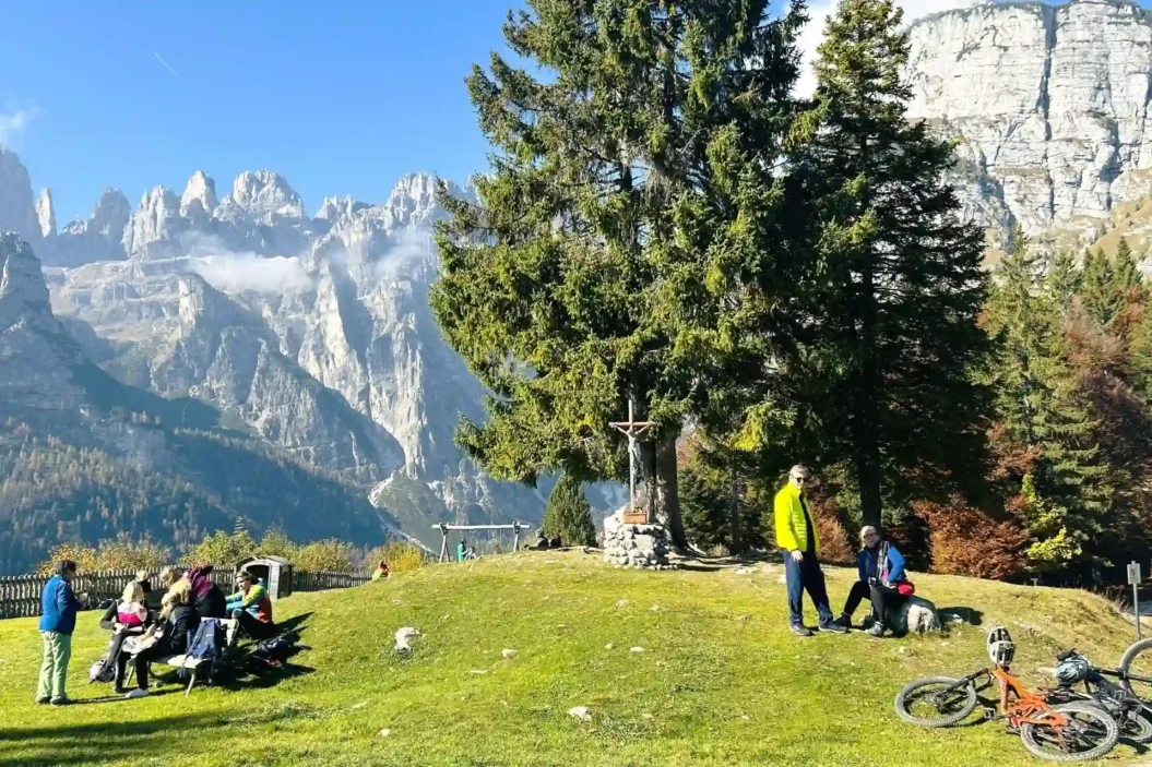 Cyclists and Hikers with view of Brenta Dolomites.