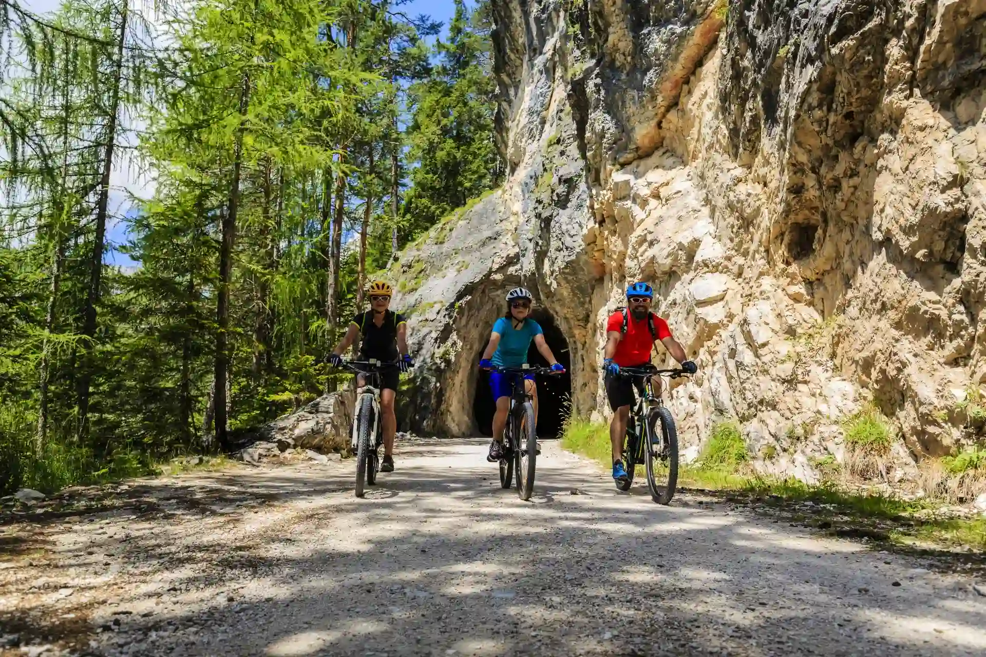 Family on eMTBs on trail near Cortina d'Ampezzo Dolomites, Italy.