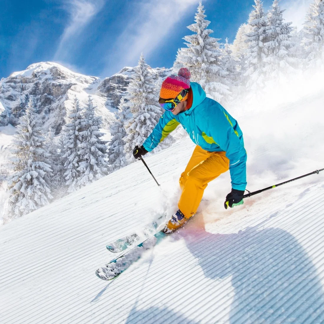 Skier on freshly groomed slopes in high mountains