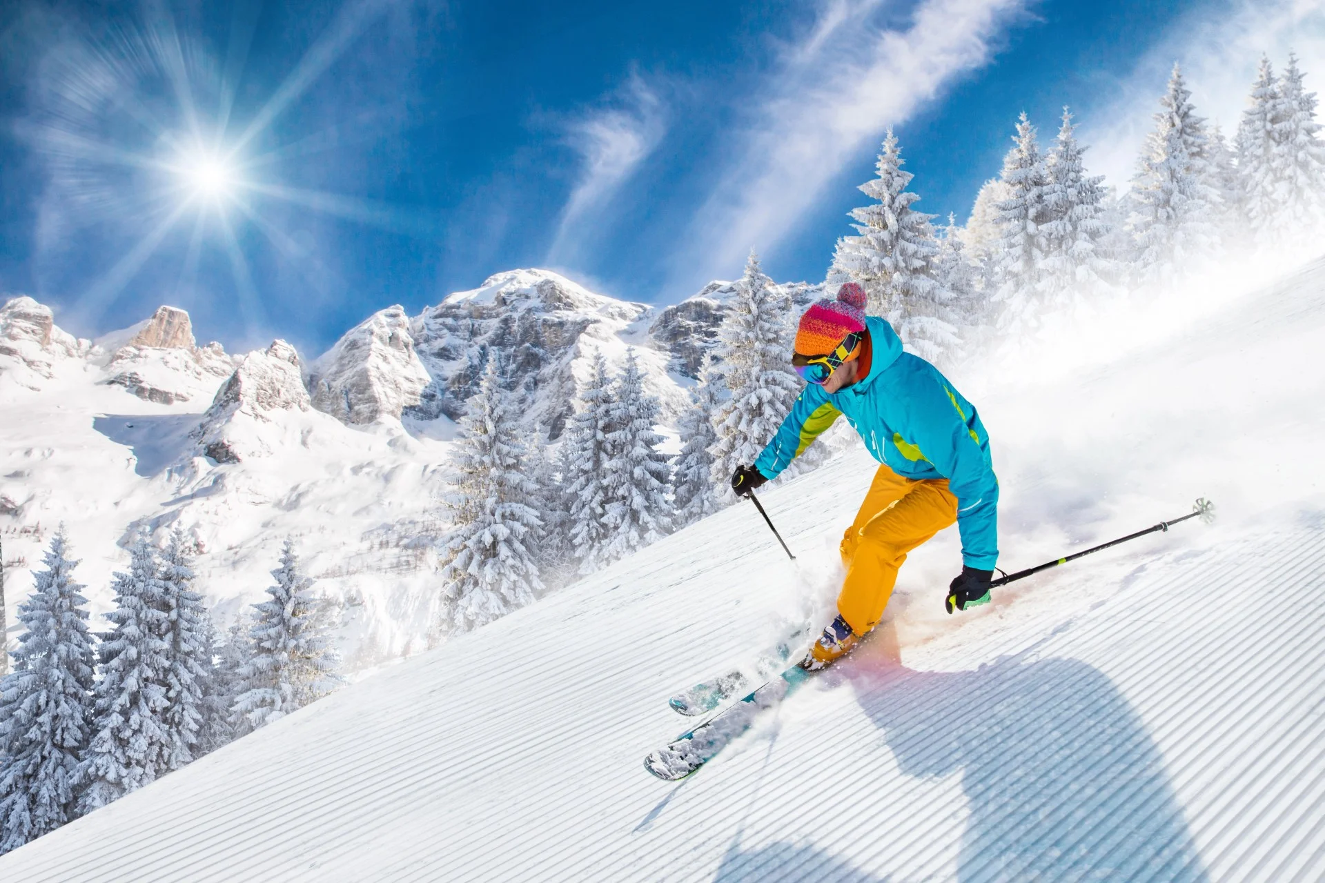 Skier on freshly groomed slopes in high mountains