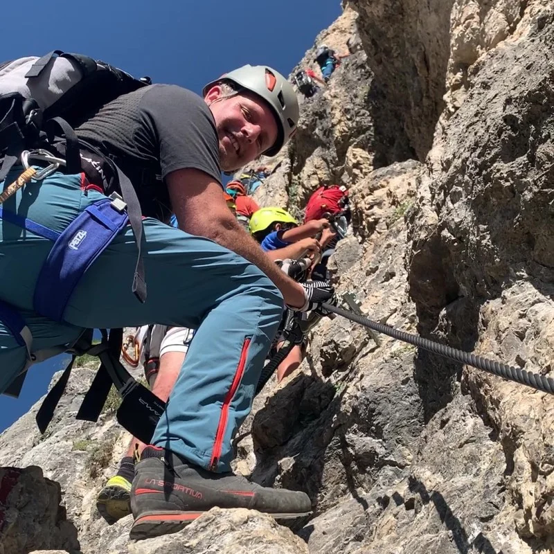 Justin doing Via Ferrata Rino Pisetta, a high, open void of a steep climb.