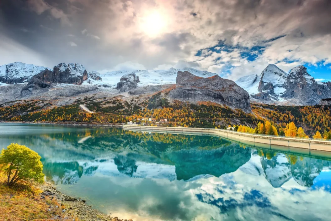 Autumn view of Lake Fedaia in Dolomites near Marmolada peak.