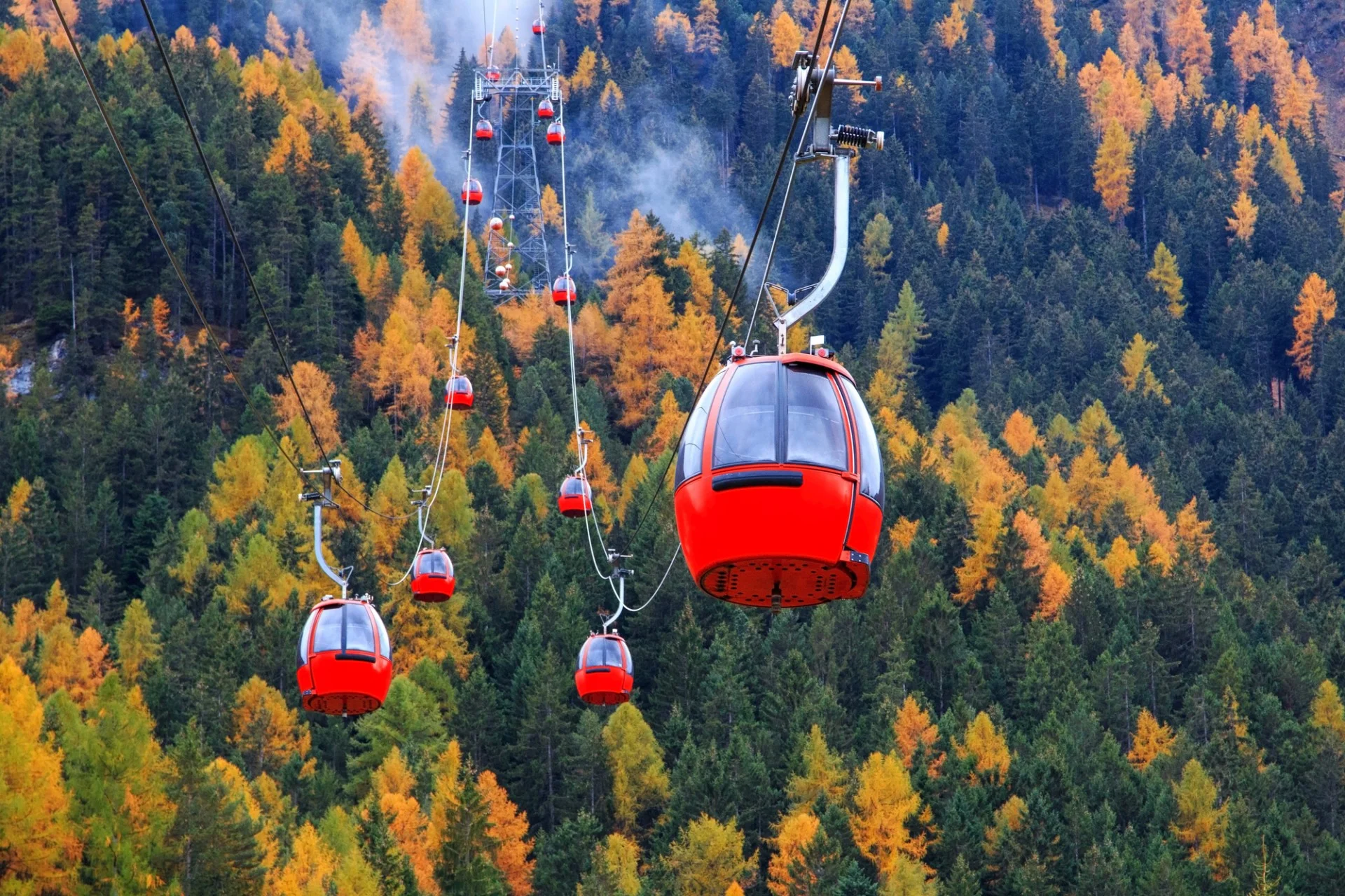 Red cable cars at Alpe di Siusi in summer.