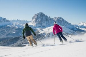 Two skiers on the slopes at Val Gardena