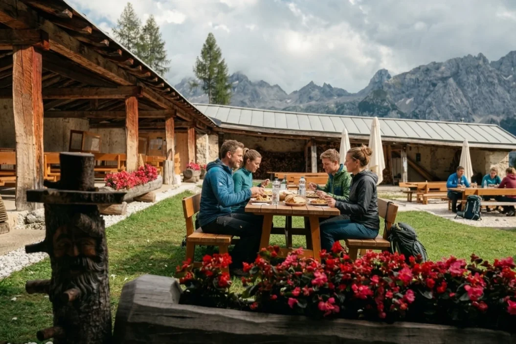 Hikers eating lunch at a mountain hut at Forcella Maraia.