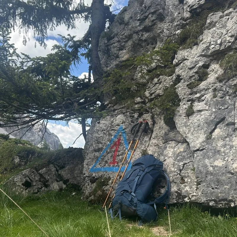 Alta Via 1 symbol with a hikers backpack and poles.