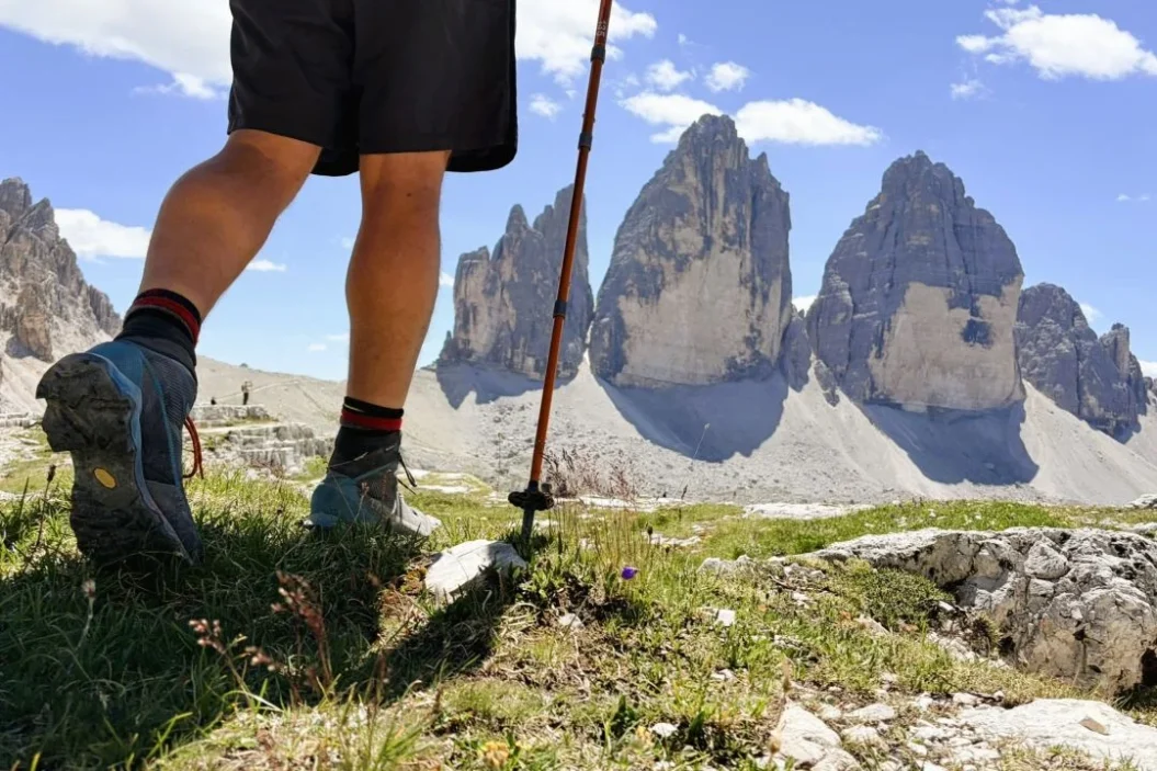 Hiker walking towards Tre Cime di Lavaredo North Face